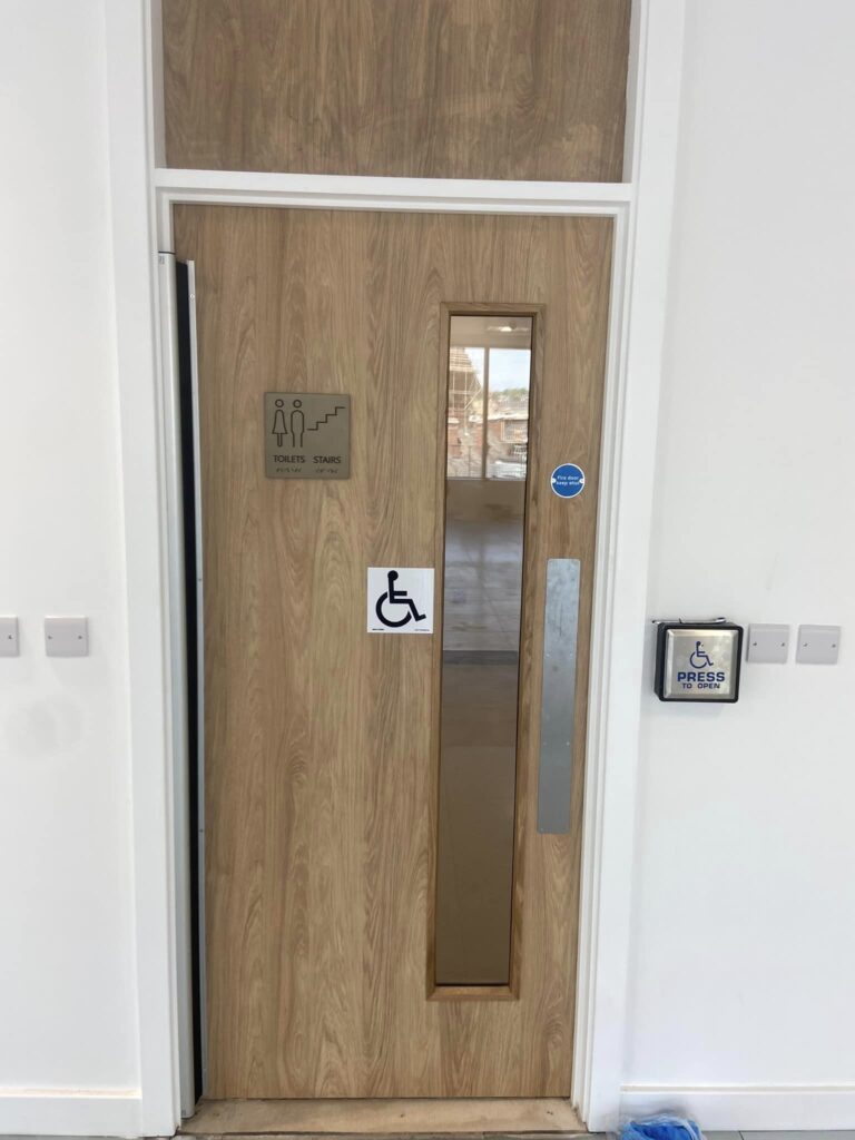 An automatic wooden disabled button activated door