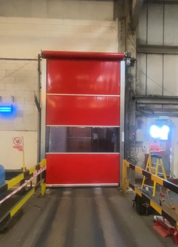 A red high speed door covering an entrance