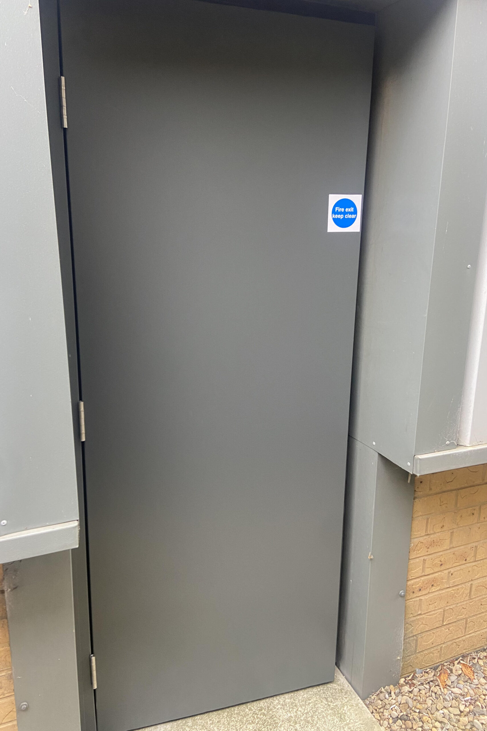 A steel fire exit door as seen from outside of a building